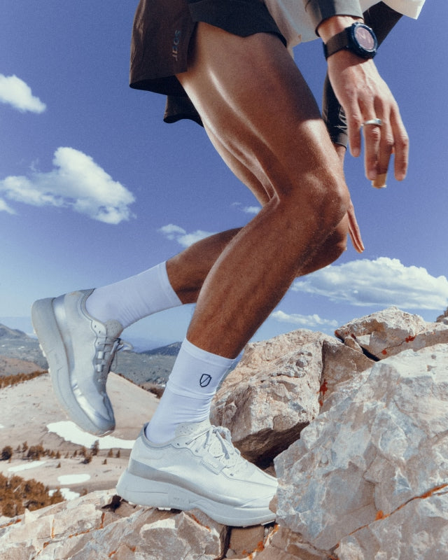 Norda 005 trail running shoe in Neve, lifestyle shot, action on the trail